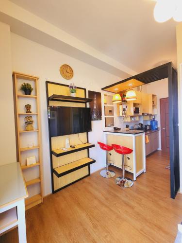 a kitchen with a counter and a stool in a room at MesaCondo Studio with Balcony in Davao City