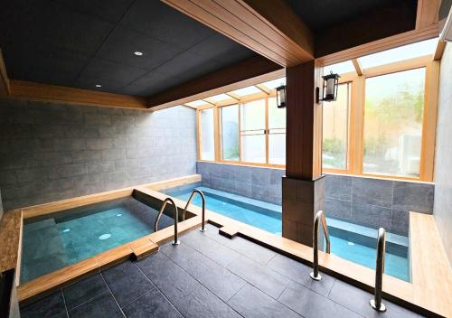 a large indoor swimming pool in a house at Zen Next Khao Yai By ZV in Pak Chong