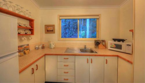 a kitchen with a sink and a microwave at The Falls Montville in Montville