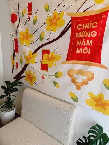 a wall with a tree and a sign on it at GREENECO DA LAT HOTEL - Khách sạn Green Eco Đà Lạt in Da Lat