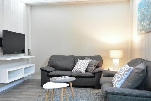 a living room with a couch and a tv at 930R-B1 The Old House in Quebec City
