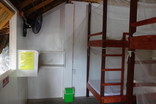a room with two bunk beds and a ladder at Lokal Home Hostel in San Juan