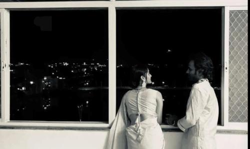 a man and a woman looking out of a window at Antariksh in Udaipur