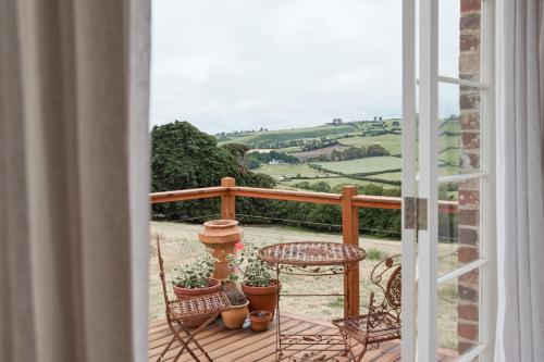 a balcony with a table and chairs and a view at Harland Rise Chapel Circa 1830 in Evandale
