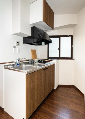 Una cocina o cocineta en 匯金上板橋ビル