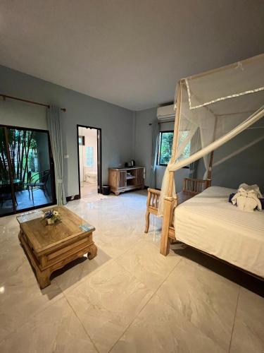 a bedroom with a bed and a coffee table at Moubillow Resort in Ao Nang Beach