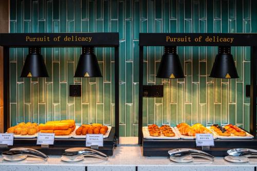 a display window of a bakery with different types of food at Hilton Garden Inn Hefei High-Tech Zone in Hefei