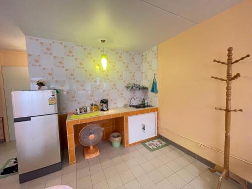 a kitchen with a refrigerator and a counter in it at Impact Arena C3 Milo in Nonthaburi