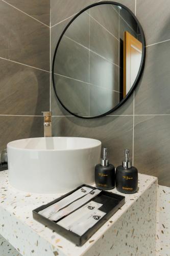 a bathroom with a mirror and a sink at The BackPacker Hotel in Da Nang