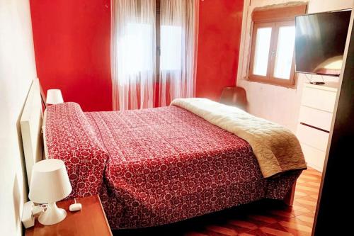 a red bedroom with a bed and a television at Welcoming House with Sea View in Corme-Porto in Corme-Puerto