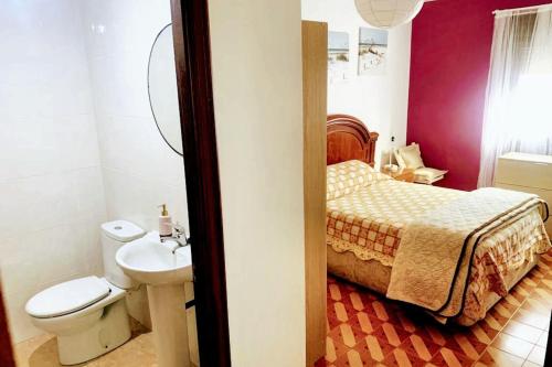 a bathroom with a bed and a toilet and a sink at Welcoming House with Sea View in Corme-Porto in Corme-Puerto