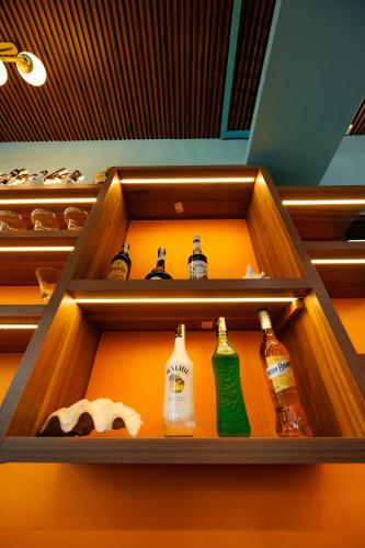 a drawer filled with different bottles of alcohol at The BackPacker Hotel in Da Nang