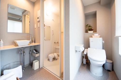 a bathroom with a toilet and a sink at Hotel Neiraku in Nara