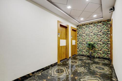 a hallway with a stone wall and a tile floor at Collection O Lotus Gold in Vadodara