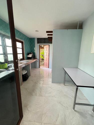 a kitchen with a counter and a table in a room at Moubillow Resort in Ao Nang Beach
