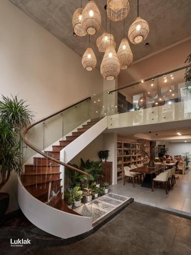 a staircase in a room with a table and a dining room at The Hota House in Hanoi