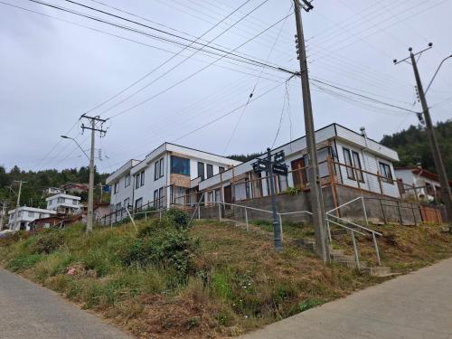 a row of houses on the side of a hill at Cabañas Eben Ezer in Queule
