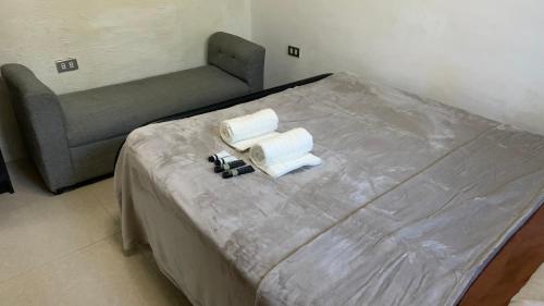 a bed in a room with a bed and a chair at Kamalig Mulogan in Molugan