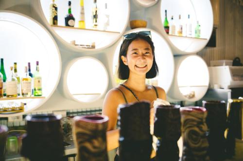 a woman standing behind a counter in a wine bar at Travel Light Bubble Diving Center in Xiaoliuqiu