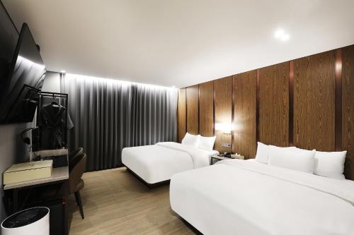 Postel nebo postele na pokoji v ubytování HOUND HOTEL Incheon Airport