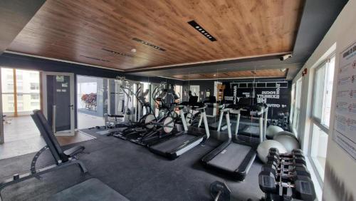 a gym with several treadmills and exercise machines at Inca inn apartments in Lima