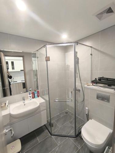 ein Badezimmer mit Dusche, Toilette und Waschbecken in der Unterkunft Glory Heights - Vinhomes Grank Park in Long Bình