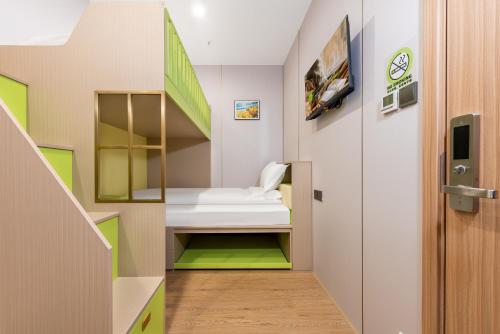 a corridor in a hospital with green and white at Lemon Hotel - Hangzhou West Lake Fengqi Road in Hangzhou