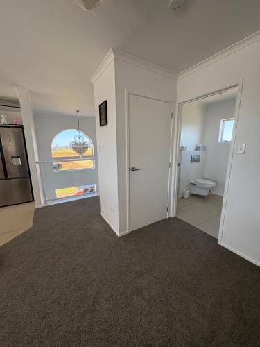 an empty living room with a toilet and a window at The lookout in New Plymouth