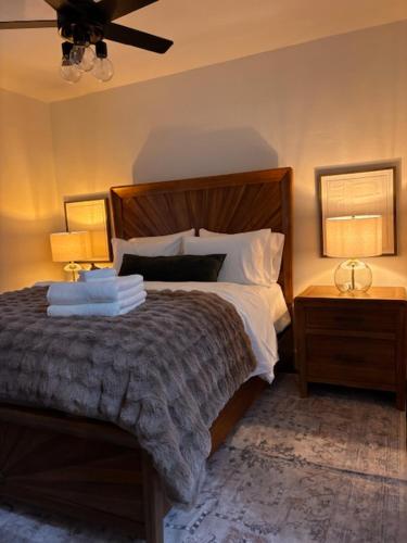 a bedroom with a bed with two lamps and two tables at My Casitas in Phoenix
