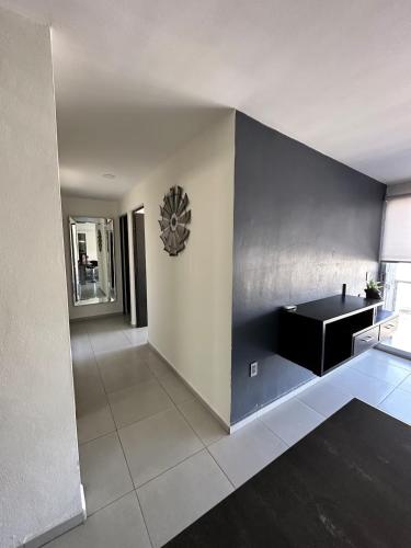 a living room with a black and white wall at Departamento De Lujo Fracc Element in San Agustín