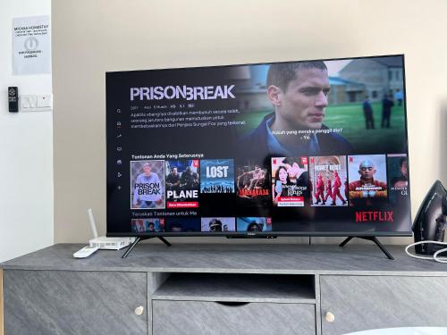 a flat screen tv sitting on top of a tv stand at Edumetro B32 3 Bedroom Subang Sunway By MICASA GROUP in Subang Jaya