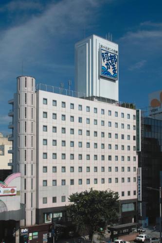 a large white building with a clock on top of it at Hotel Crown Hills Sendai Aobadori in Sendai