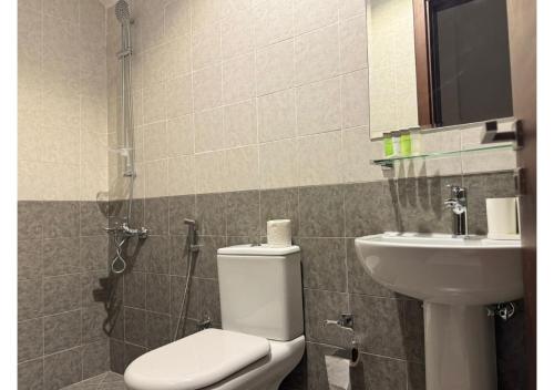 a bathroom with a toilet and a sink at 1 - BLUE WORLD - Al Dana Villas in Fujairah