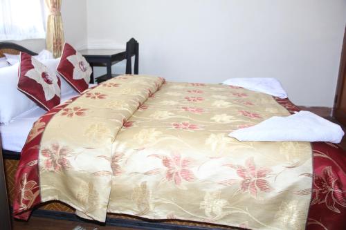 a bed with a blanket on it in a room at Elbrus Home in Kathmandu
