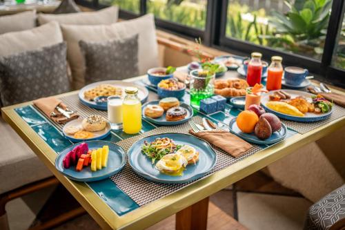 a table full of breakfast foods and drinks at TUI BLUE Berawa Hotel and Villas in Canggu