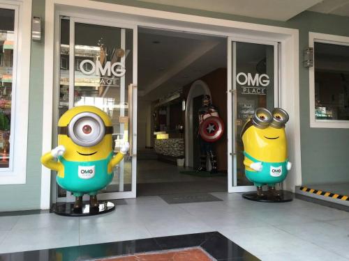 two cartoon characters are in front of a store at OMG Hotel in Khon Kaen