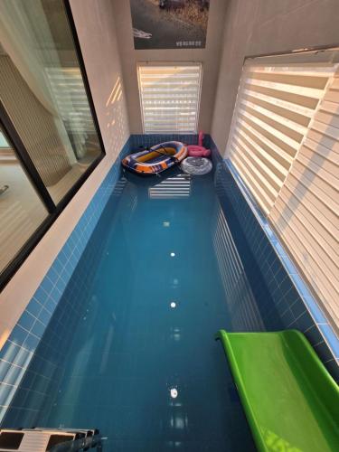 a swimming pool with a boat in the middle at Daori Pension in Boryeong