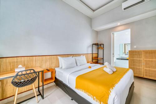 a bedroom with a bed and a chair in it at Petite 2bd Fully Equipped Home in Canggu in Kerobokan