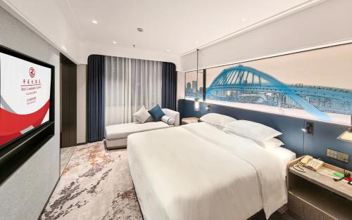 a hotel room with a large bed and a tv at Hotel Landmark Canton in Guangzhou
