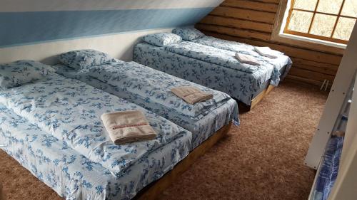 two beds in a room with blue sheets at Reimani Holiday House in Vanaveski