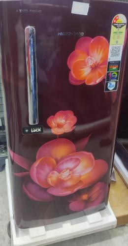 a refrigerator with flowers painted on the side of it at The Hills Studio Appartment in Tiruvannāmalai