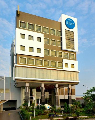 a building with a sign on the side of it at Hotel Dafam Pekalongan in Pekalongan