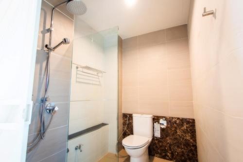 a bathroom with a toilet and a shower at Klongrien Boutique Hotel in Hat Yai