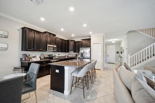 a kitchen and living room with a couch and a table at Tampa Private Home Game Room Theater Room & more in Riverview