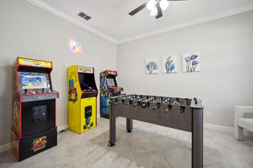 a room with two arcade games and a gaming console at Tampa Private Home Game Room Theater Room & more in Riverview