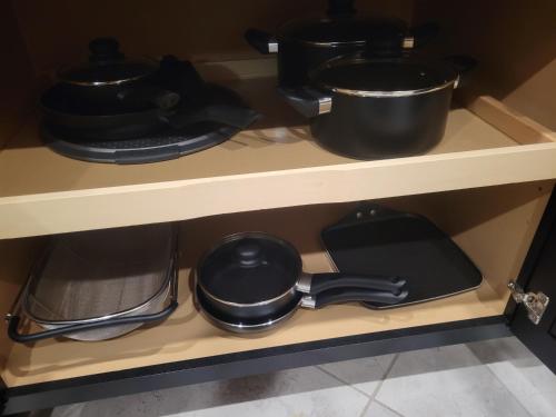 a shelf with pots and pans on it at Tampa Private Home Game Room Theater Room & more in Riverview