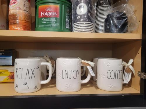 a shelf with two coffee mugs with the words relax and no at Tampa Private Home Game Room Theater Room & more in Riverview