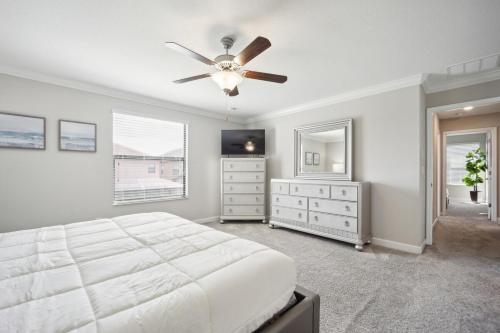 a bedroom with a bed and a ceiling fan at Tampa Private Home Game Room Theater Room & more in Riverview