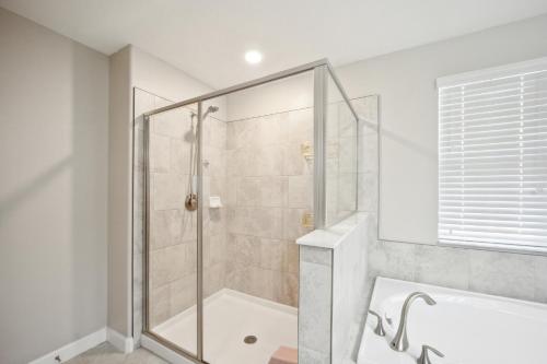 a bathroom with a shower and a bath tub at Tampa Private Home Game Room Theater Room & more in Riverview