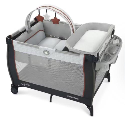 a newborn infant crib with a cot mattress and a basket at Tampa Private Home Game Room Theater Room & more in Riverview